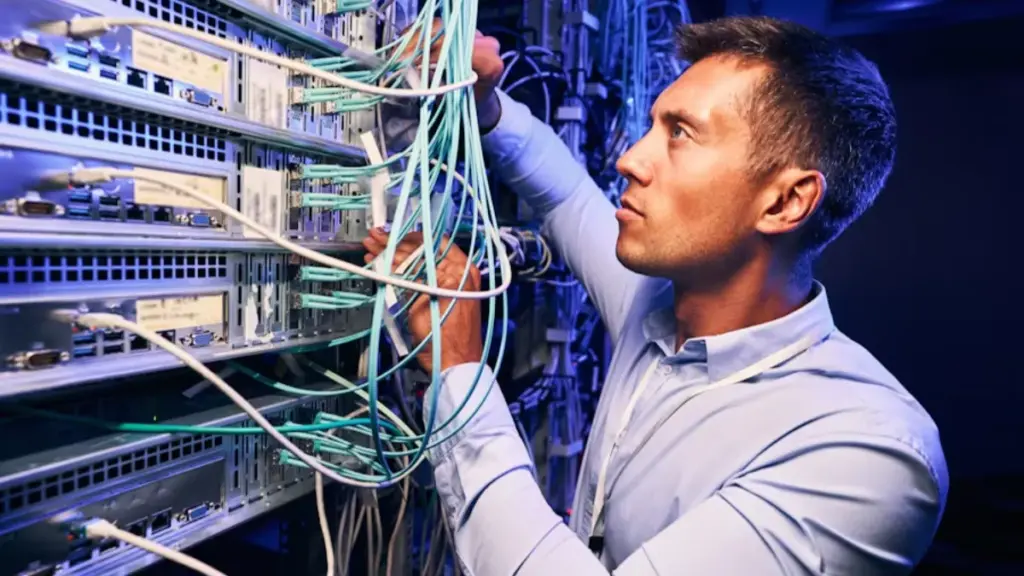 serious-concentrated-data-center-it-technician-checking-network-cables-connected-to-server