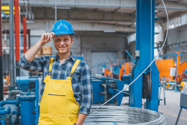 Portrait of happy young businessman working in factory