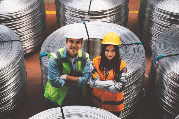 Portrait of smiling two industry employees in factory warehouse