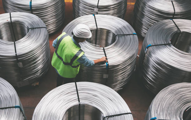 Young engineer man checking production line in wire warehouse