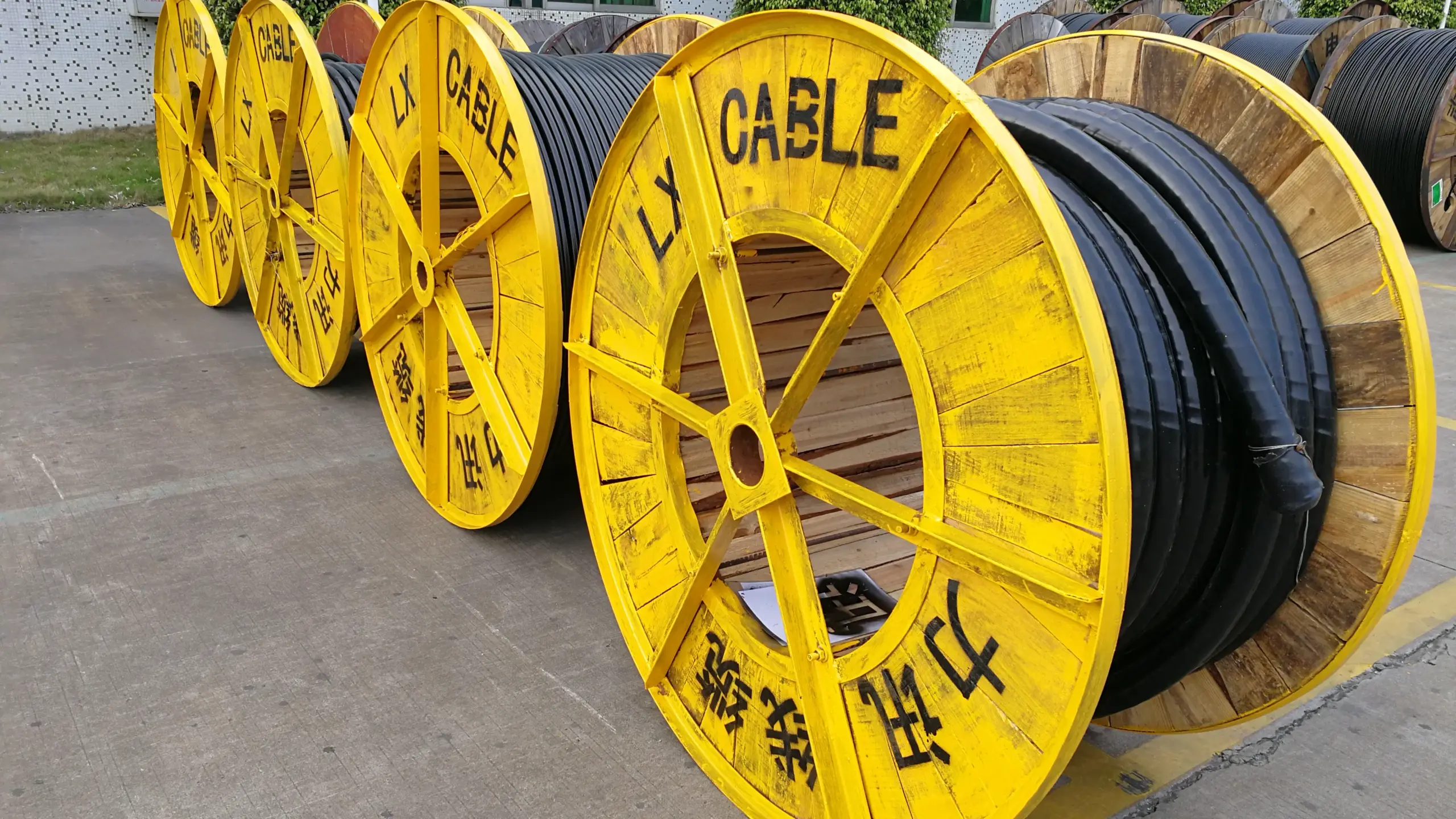Large industrial cable reels stockpiled at cable factory warehouse